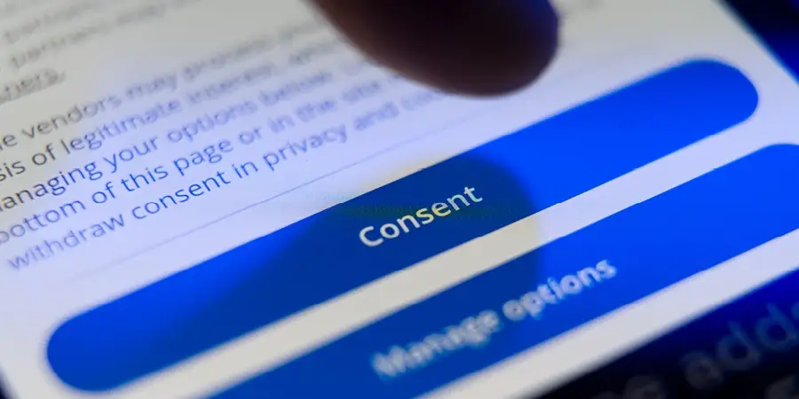A blue button on a website with consent written on it in white.