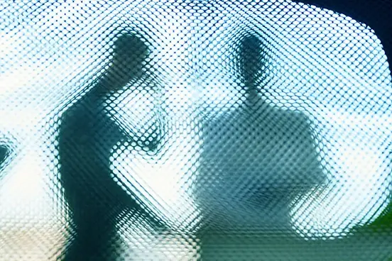 Pixelated image of two people.